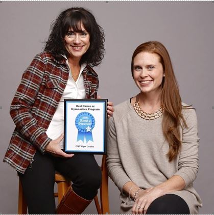 Michelle Gregory and Lauren Tassini (Owner) holding the Best Dance or Gymnastics Program award